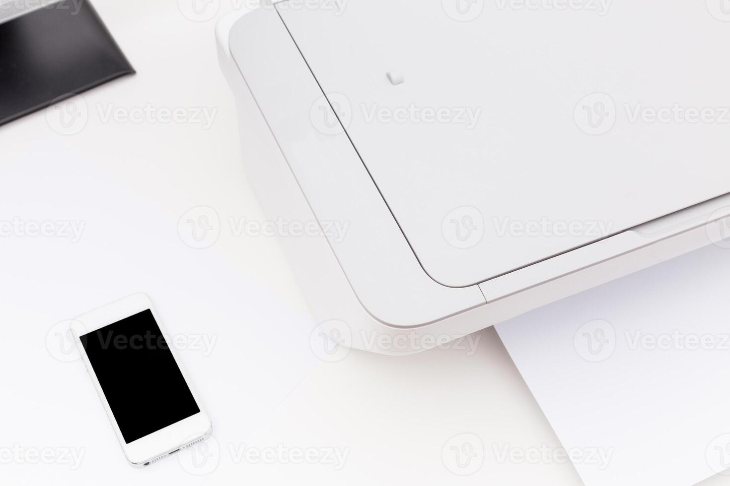 Home office setup featuring a printer, smartphone, and documents on a clean desk space photo