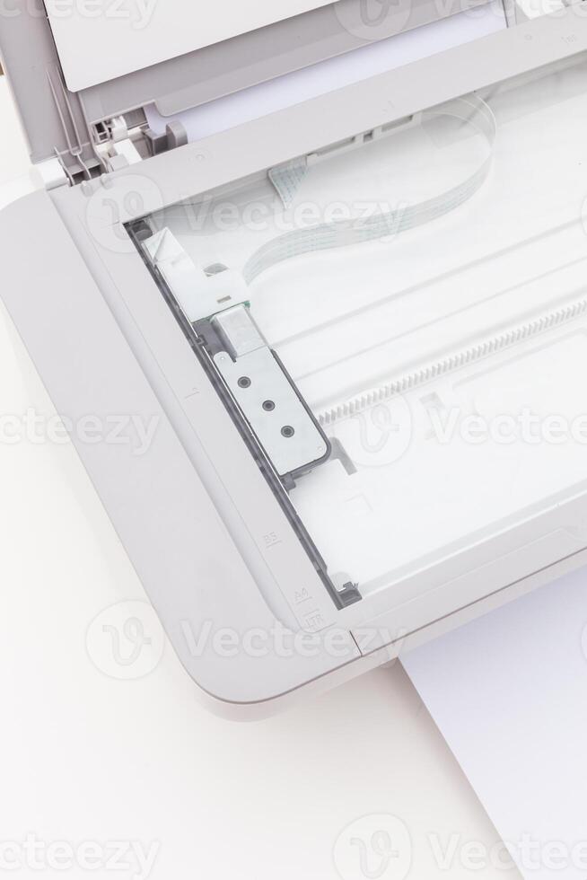 Modern scanner showing internal mechanism and paper path on a clean white surface photo