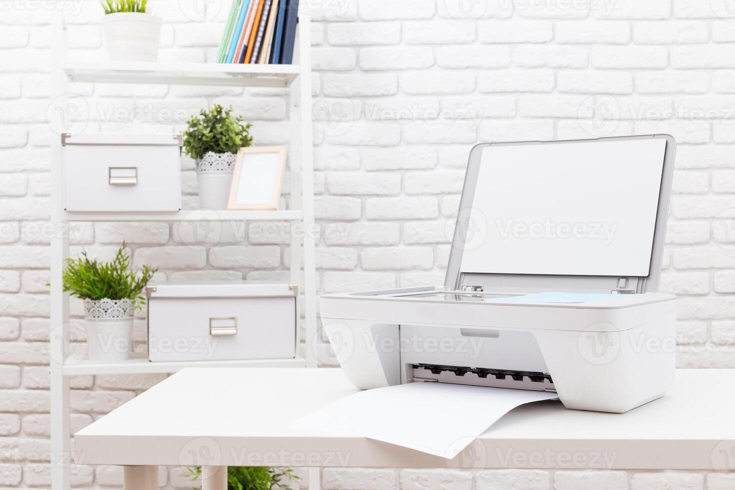Printing documents in a modern workspace with a sleek printer on a white table against a brick wall photo