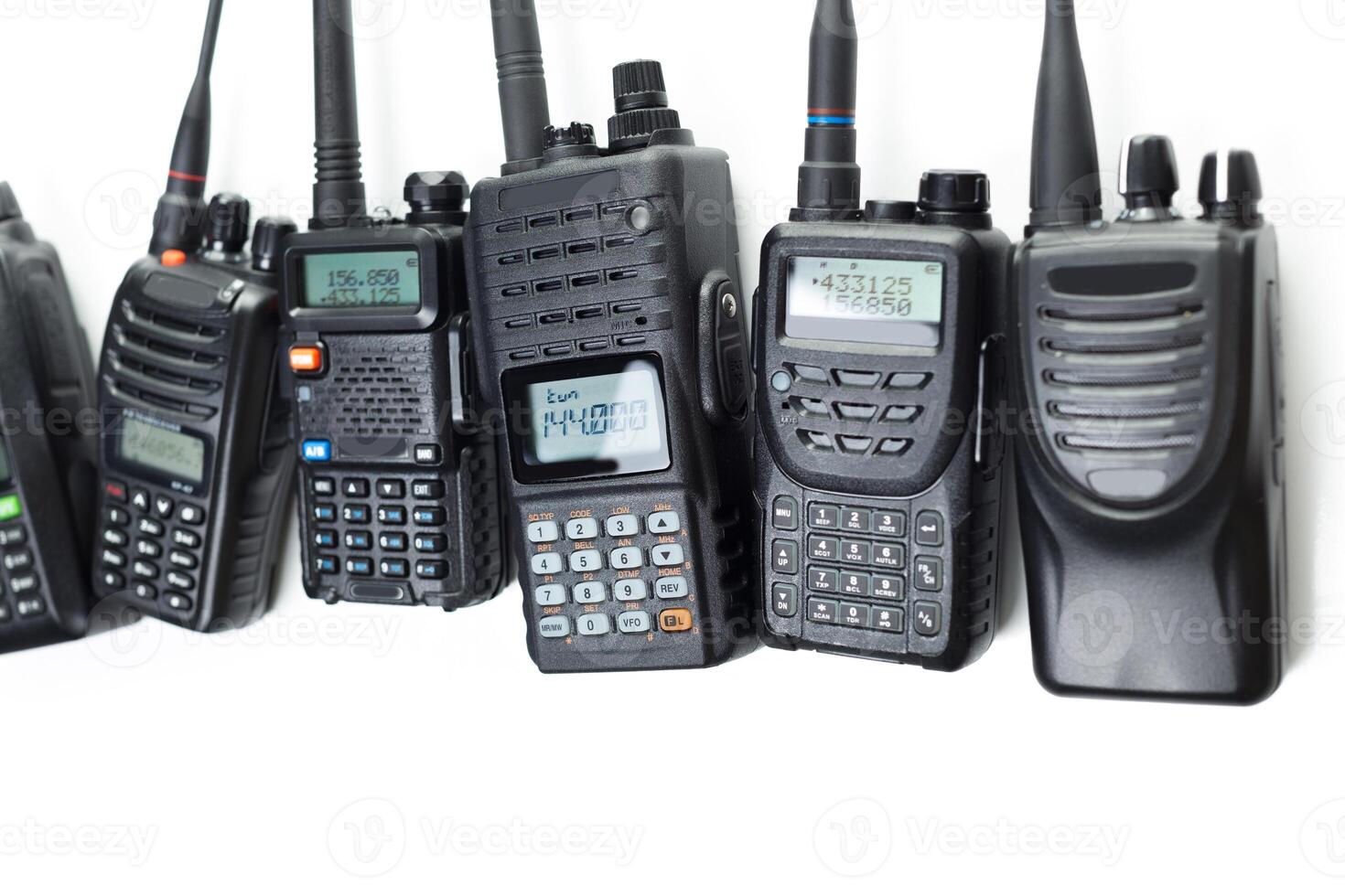 Different types of two-way radios lined up for communication and signaling in various settings photo