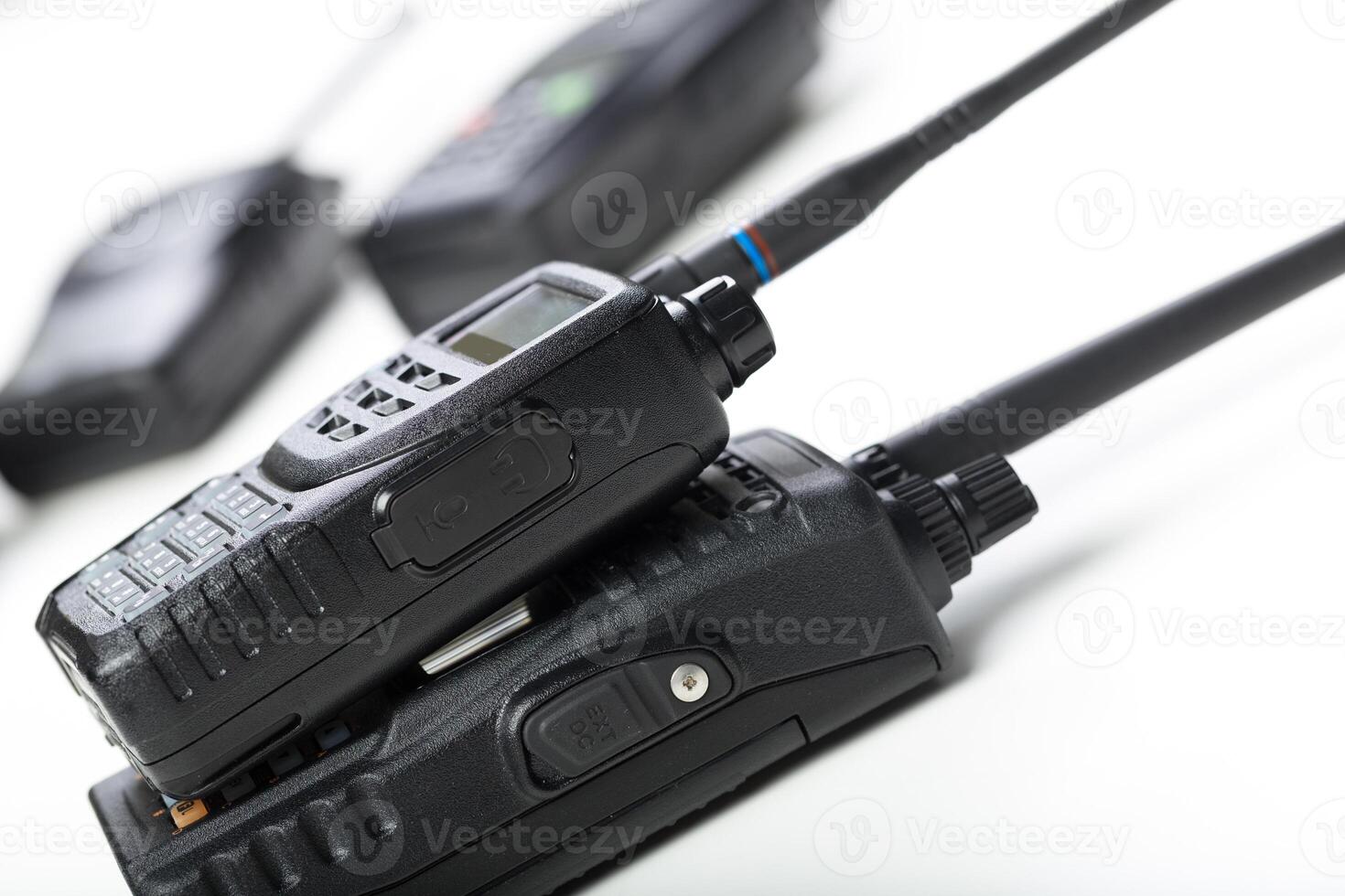 Communication devices stacked on a table in a modern workspace setting for efficient teamwork and coordination photo