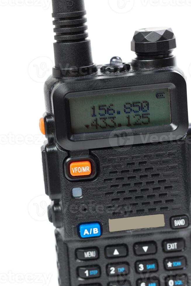 Handheld radio device displaying frequency and settings for communication in a modern context photo