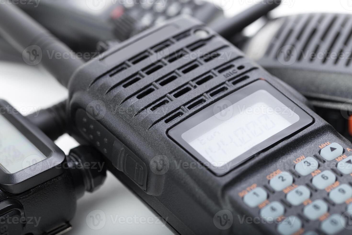 Communication devices for emergency services displayed on a white surface in a professional setting photo