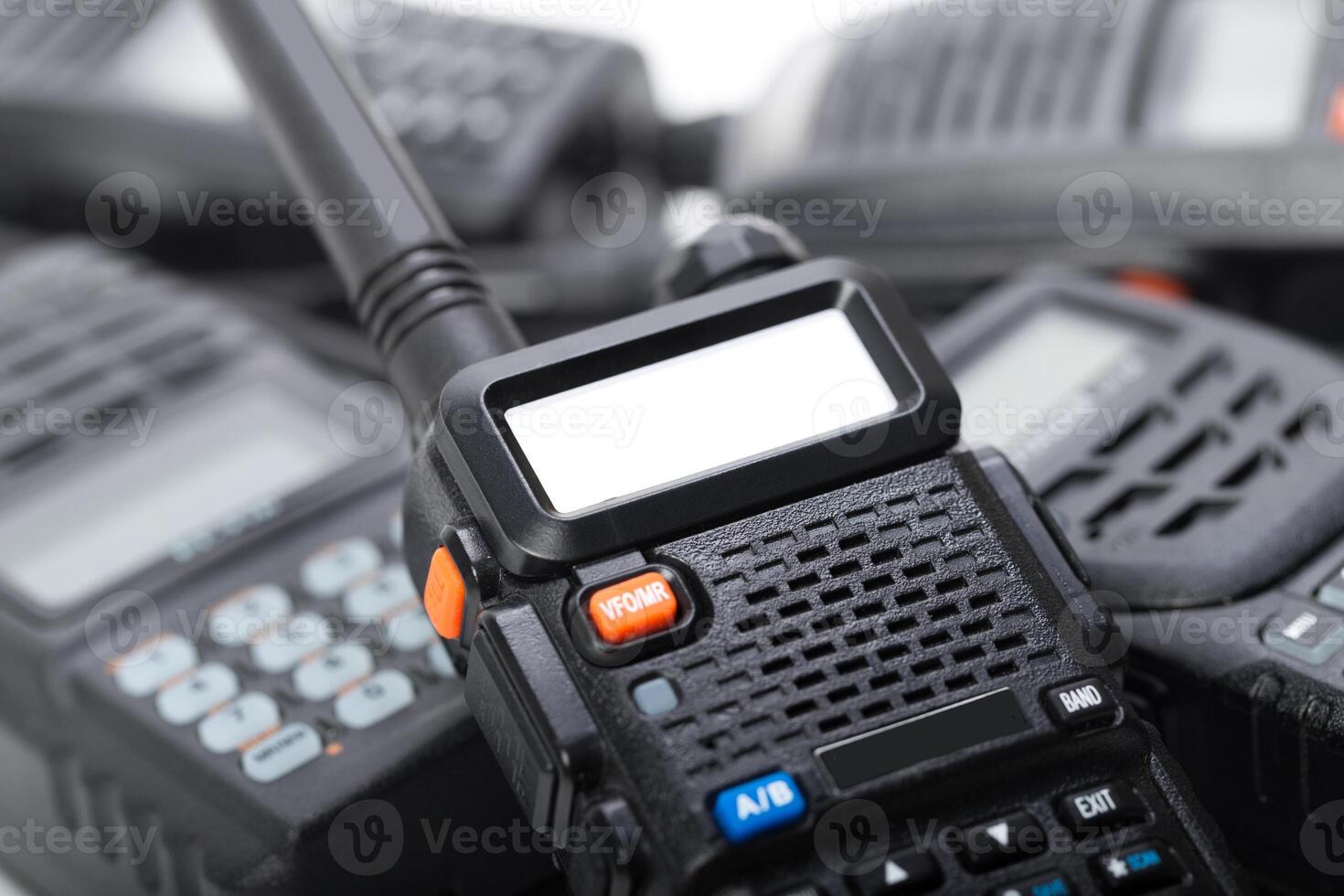 Communication devices stack highlighting handheld radios used for various activities in emergency and outdoor settings photo