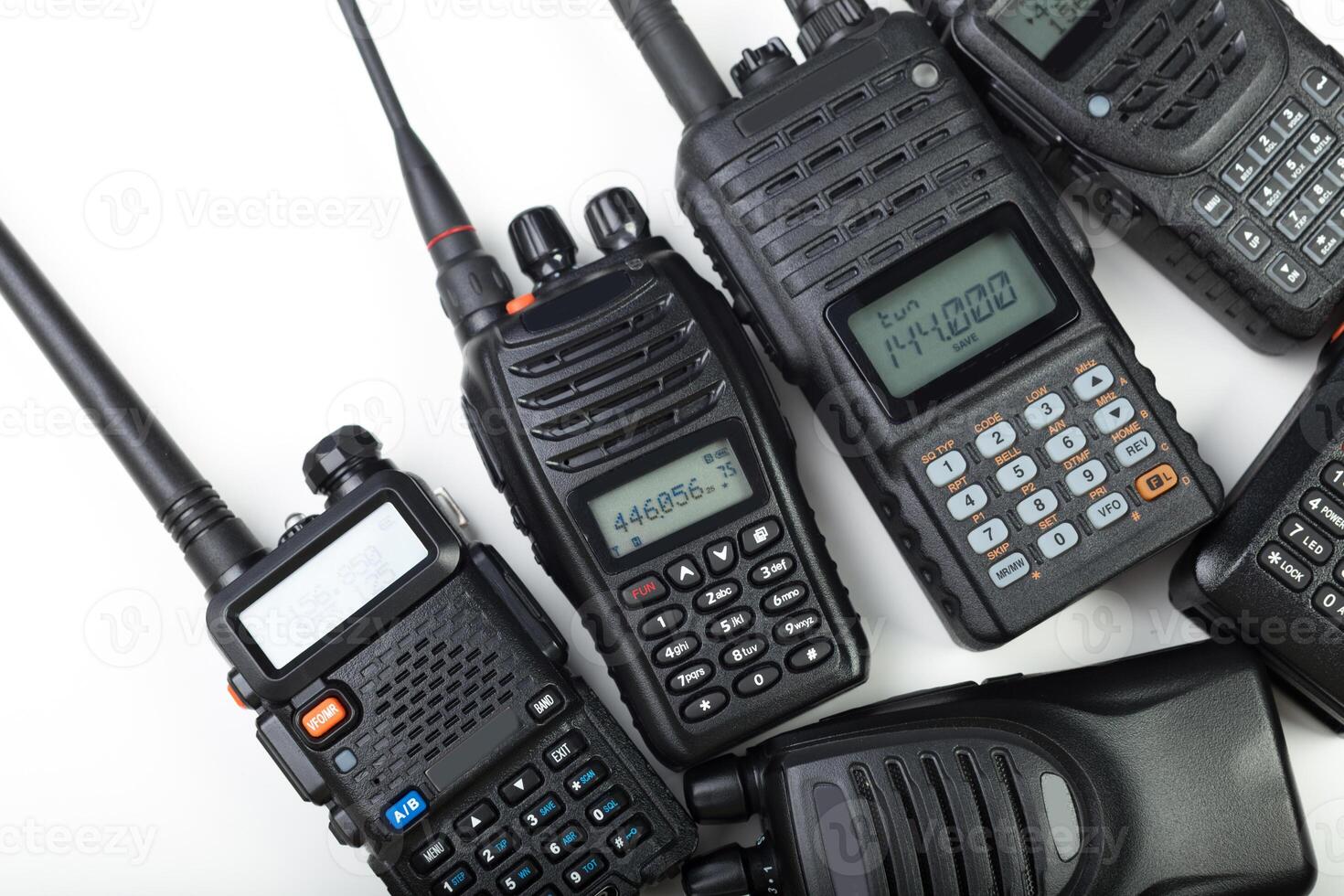 Various handheld radios arranged in a flat layout highlighting communication devices used for versatile operations photo