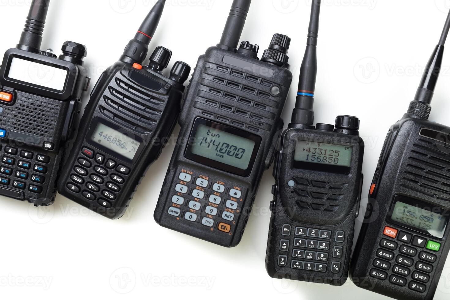 Collection of handheld radios for communication used by enthusiasts and professionals photo