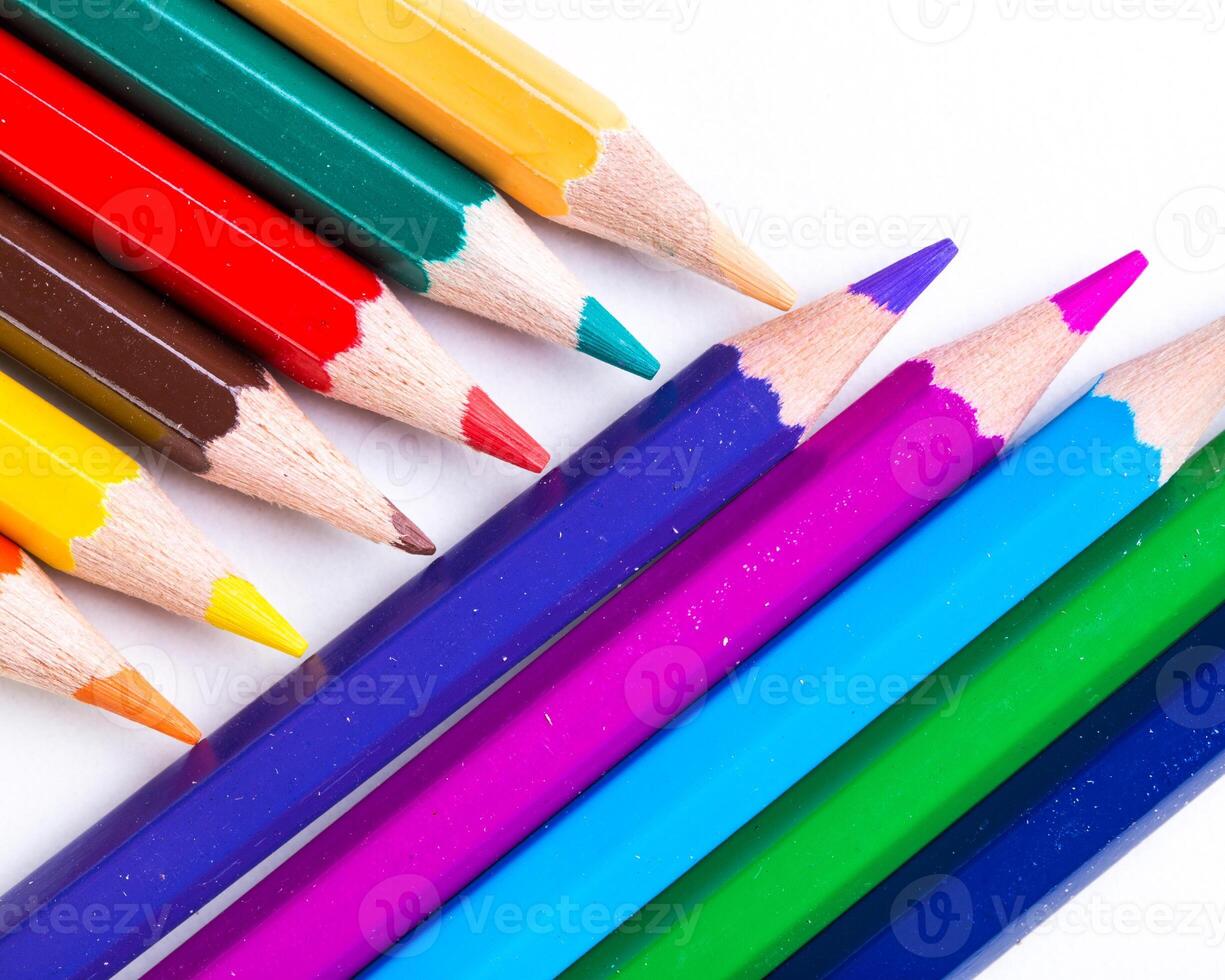 Colorful assortment of colored pencils arranged creatively in a vibrant display on a white background photo
