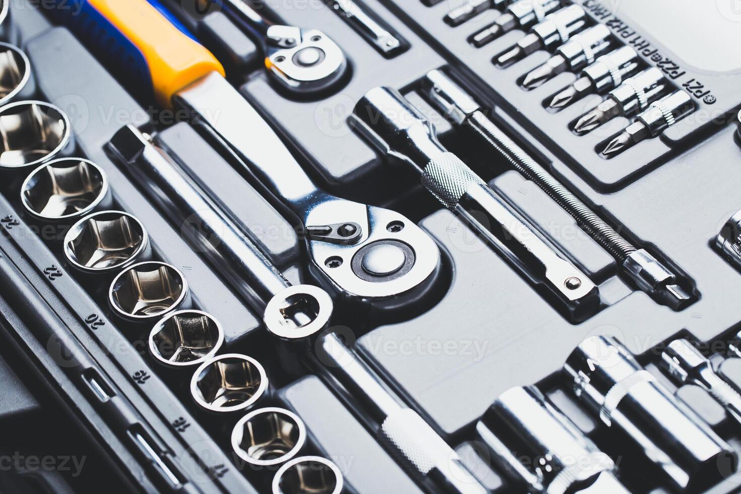 Tool set arranged neatly in a toolbox showcasing various wrenches and sockets for automotive repairs in a workshop setting photo