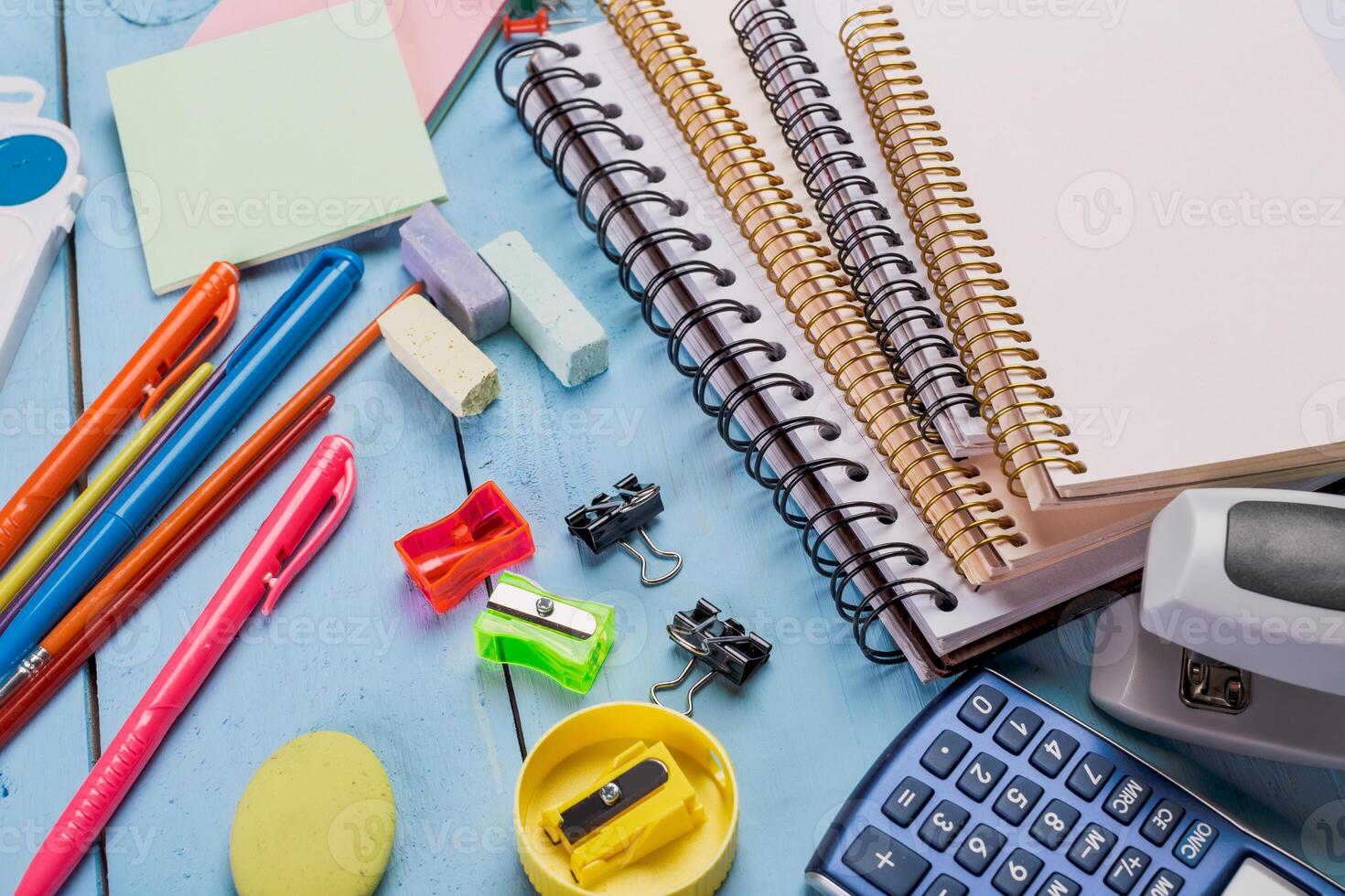 Supplies on a desk include notebooks, pens, and stationery for study or organization at a workspace photo
