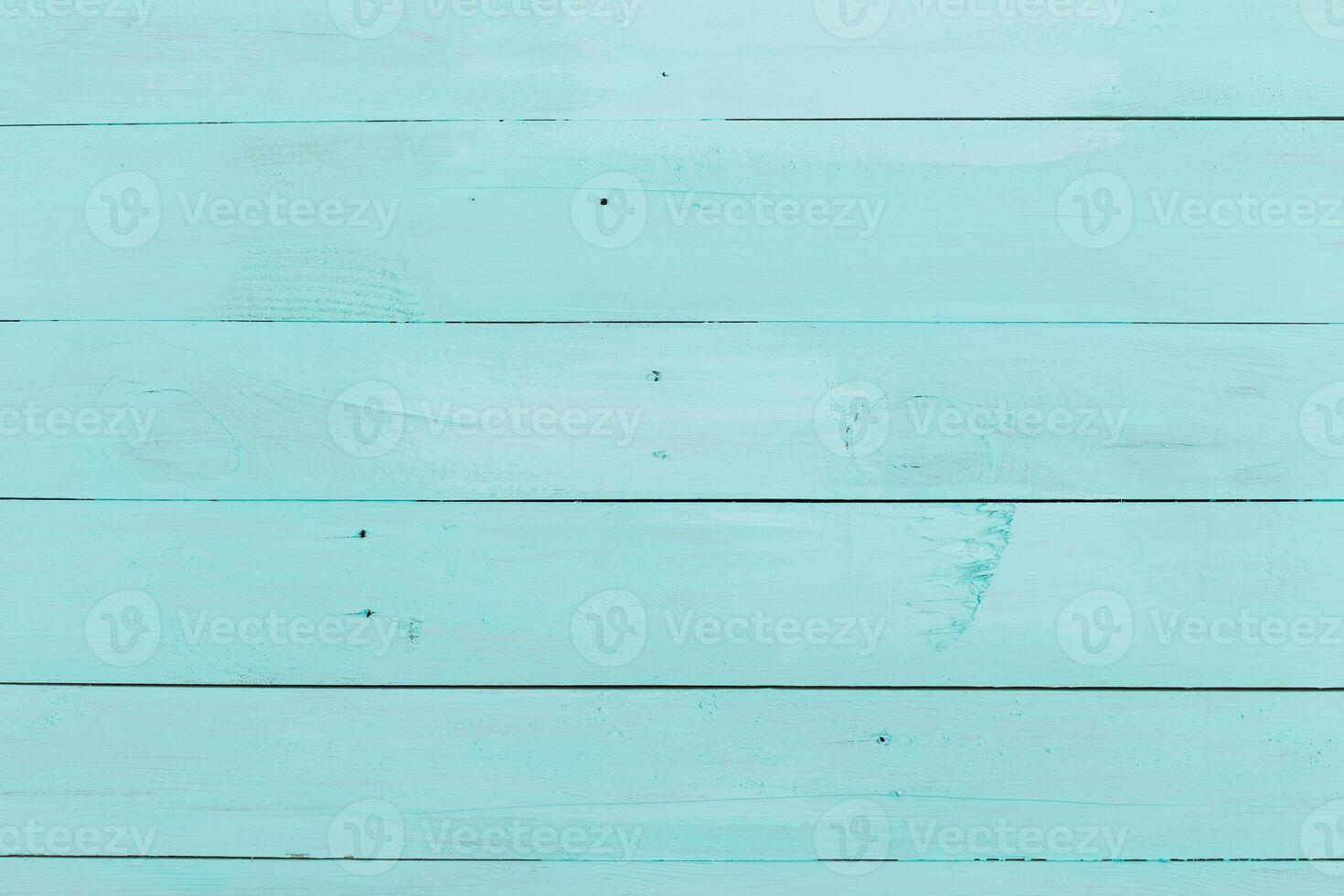 Vibrant turquoise wooden surface with visible grain patterns and slight wear marks photo