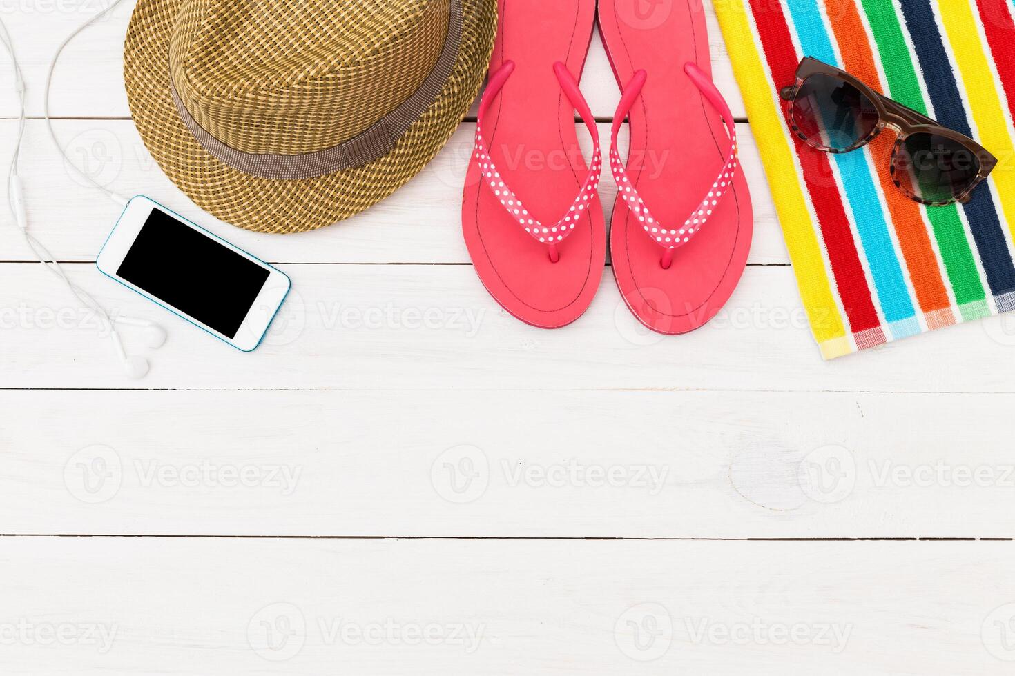 Bright summer beach essentials arranged on a white wooden surface for a relaxing day by the sea photo
