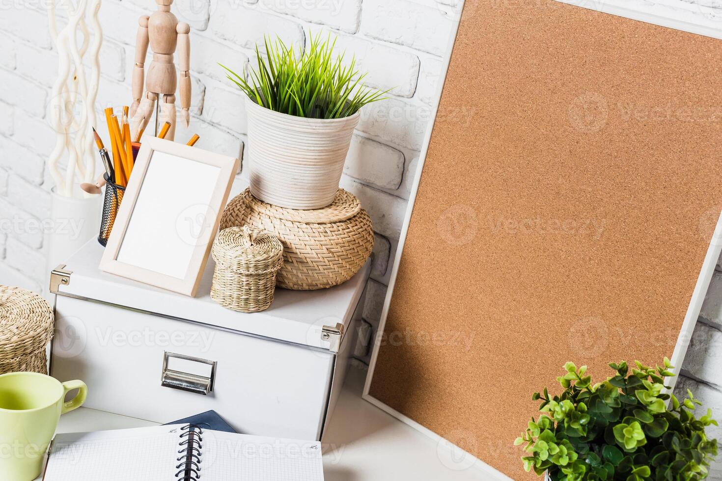 Minimalist workspace featuring greenery and organizational tools in a cozy setting photo