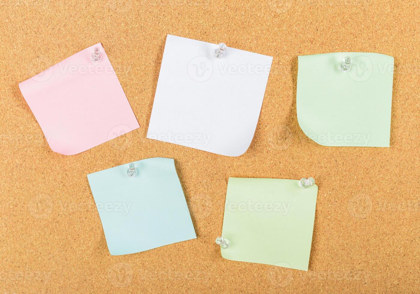 Colorful sticky notes arranged on a corkboard for reminders and organization photo