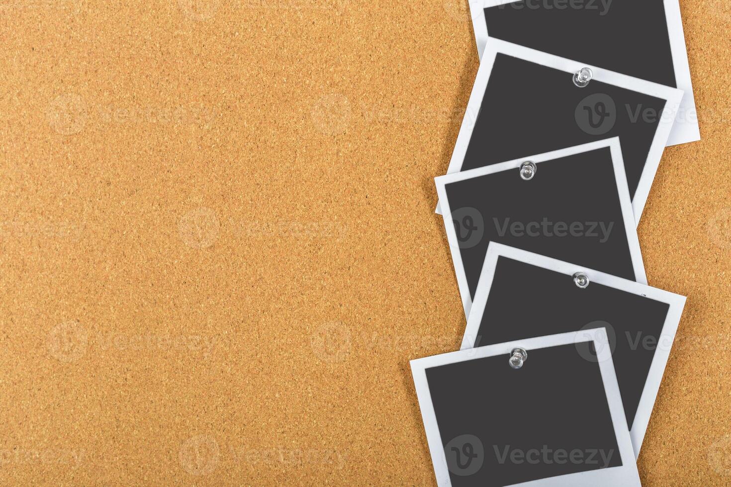 Collection of empty photo frames pinned on a corkboard ready for memories to be captured and displayed creatively