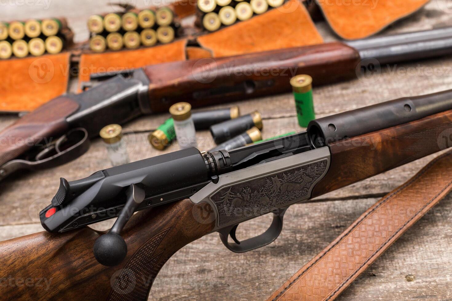 Exquisite craftsmanship and detail of hunting rifles and ammunition on a wooden surface indoors photo