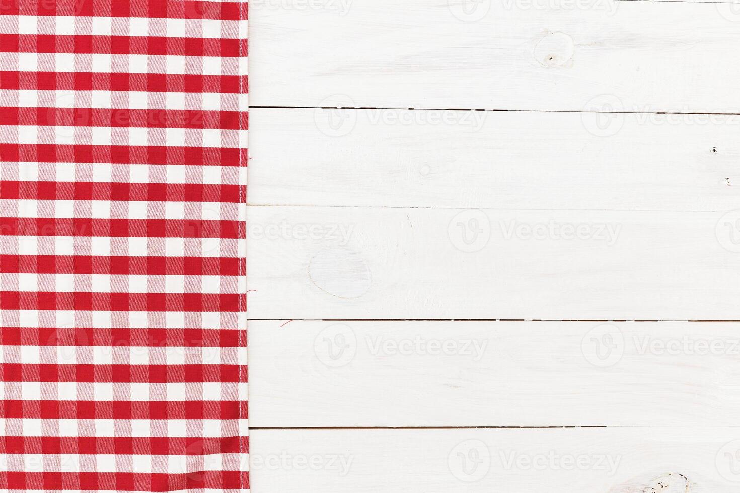 Red and white checkered tablecloth placed on a clean wooden table with rustic finish for a cozy dining experience photo