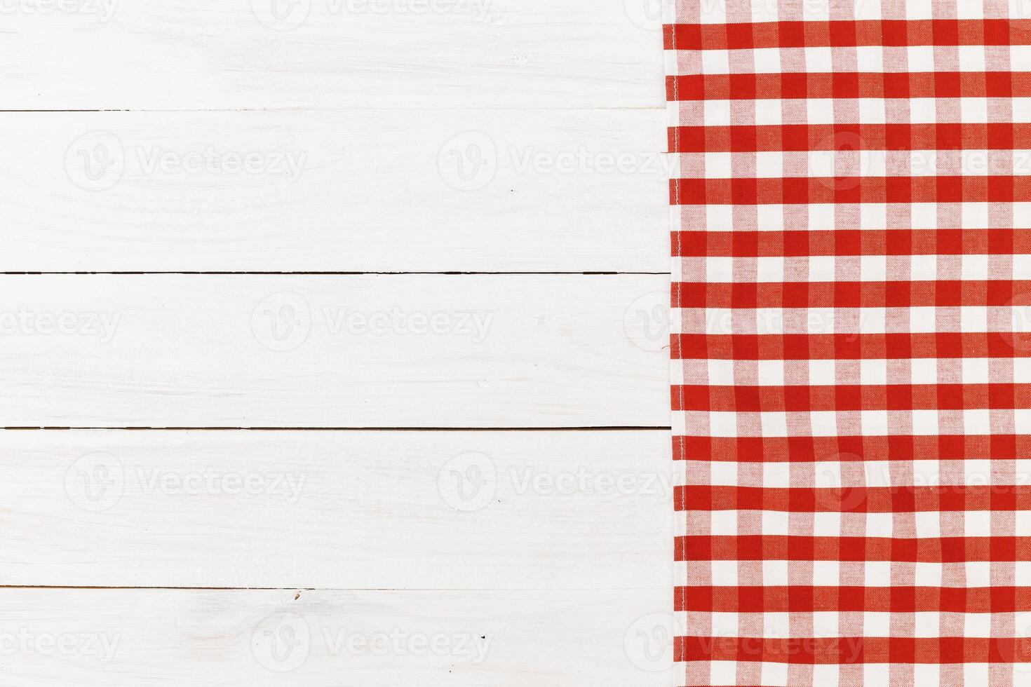 Red and white checkered tablecloth on wooden surface creating a cozy dining atmosphere photo