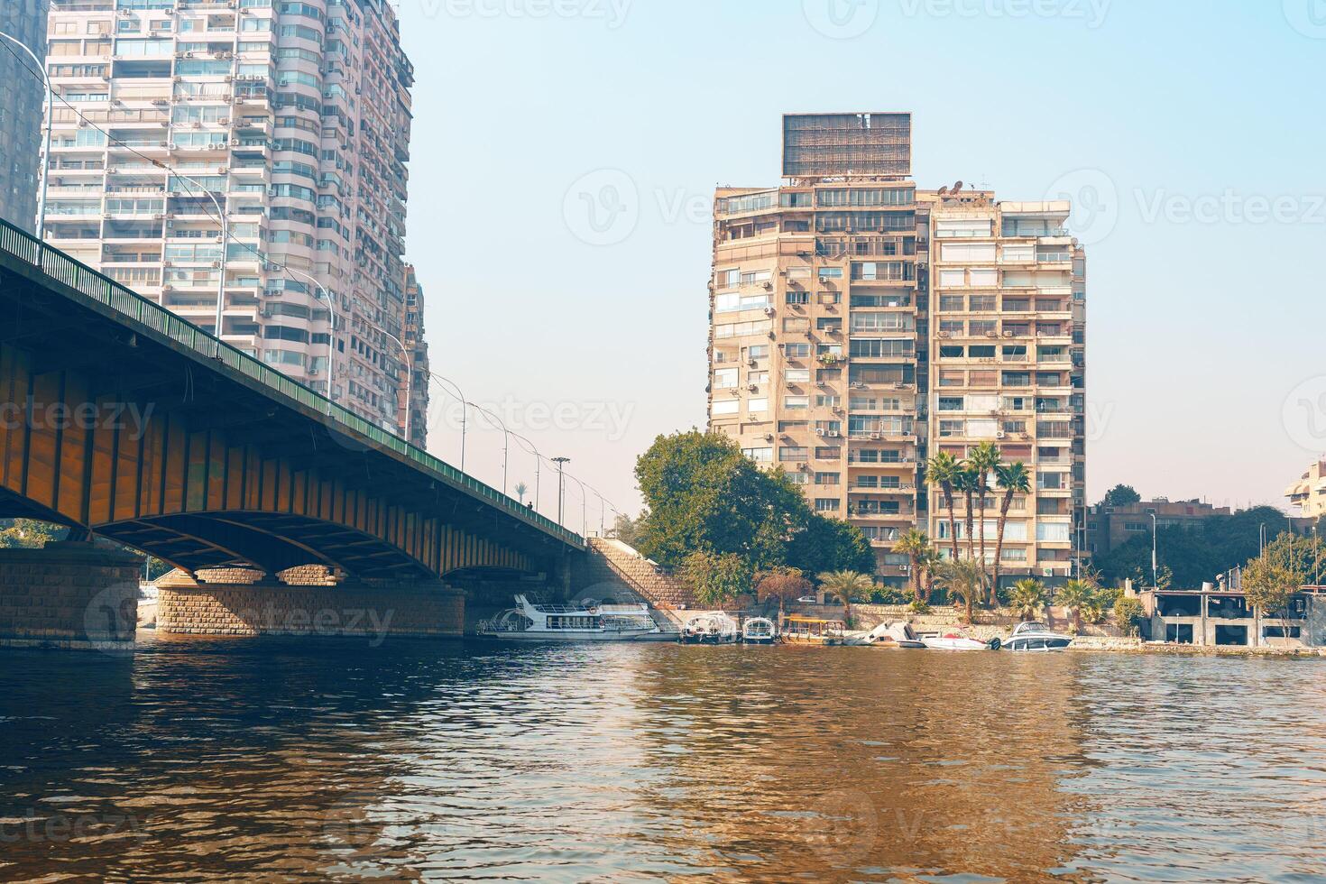 Cityscape view of Cairo with a bridge crossing the Nile River under the sunlight photo