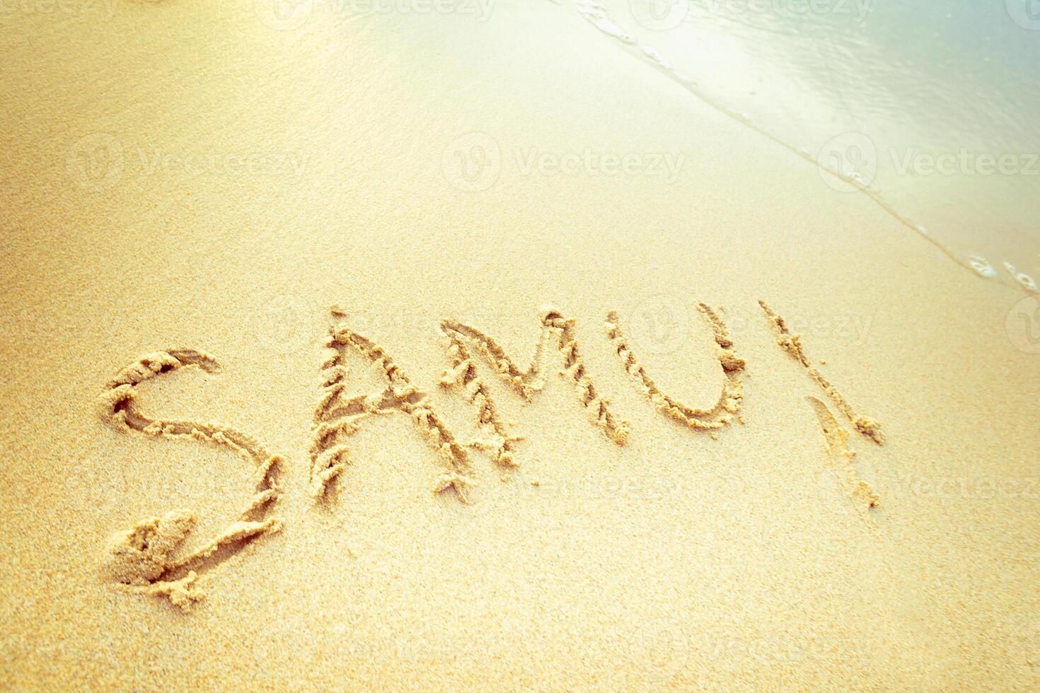 Message written in sand on a warm beach, capturing a personal moment during a sunny day by the ocean photo
