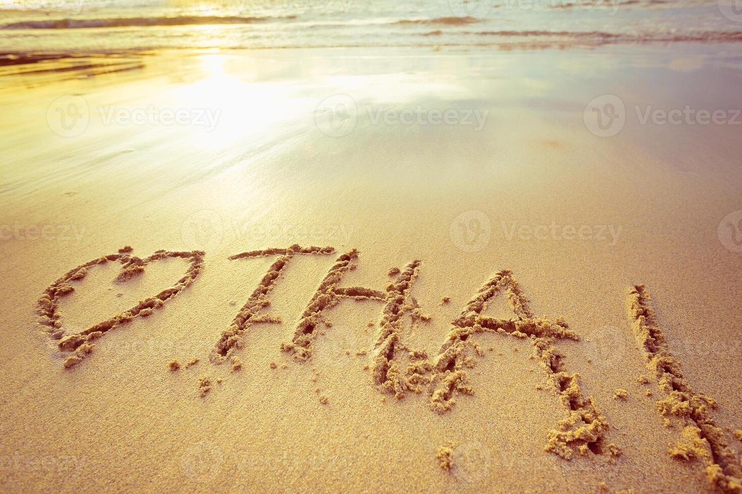 Message of love written in sand at sunset on a serene beach photo