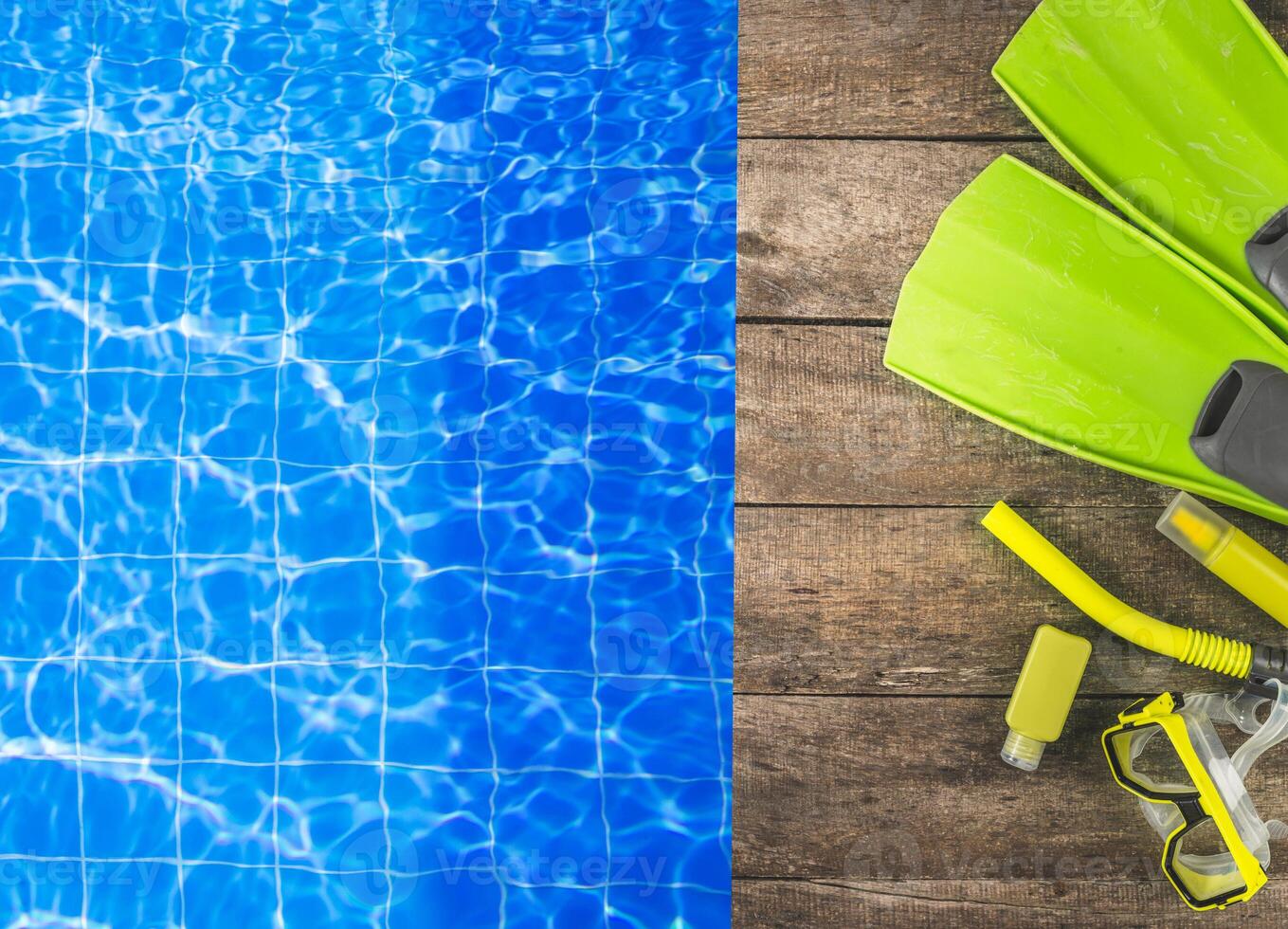 Bright blue swimming pool with snorkeling gear laid out on wooden deck during sunny day for aquatic exploration photo