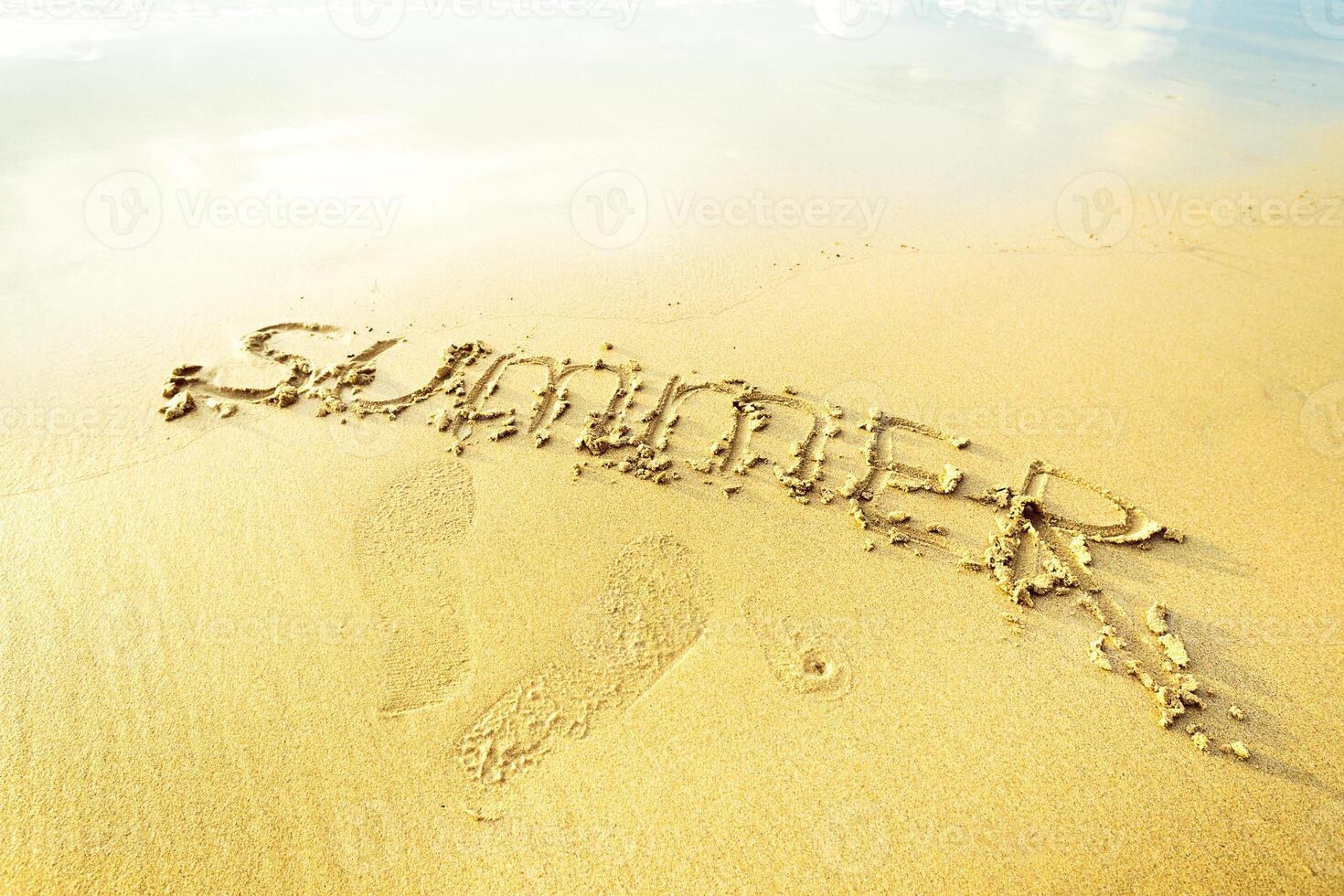 Warm sand with summer written in it captures the essence of a beach day in the sun during vacation season photo