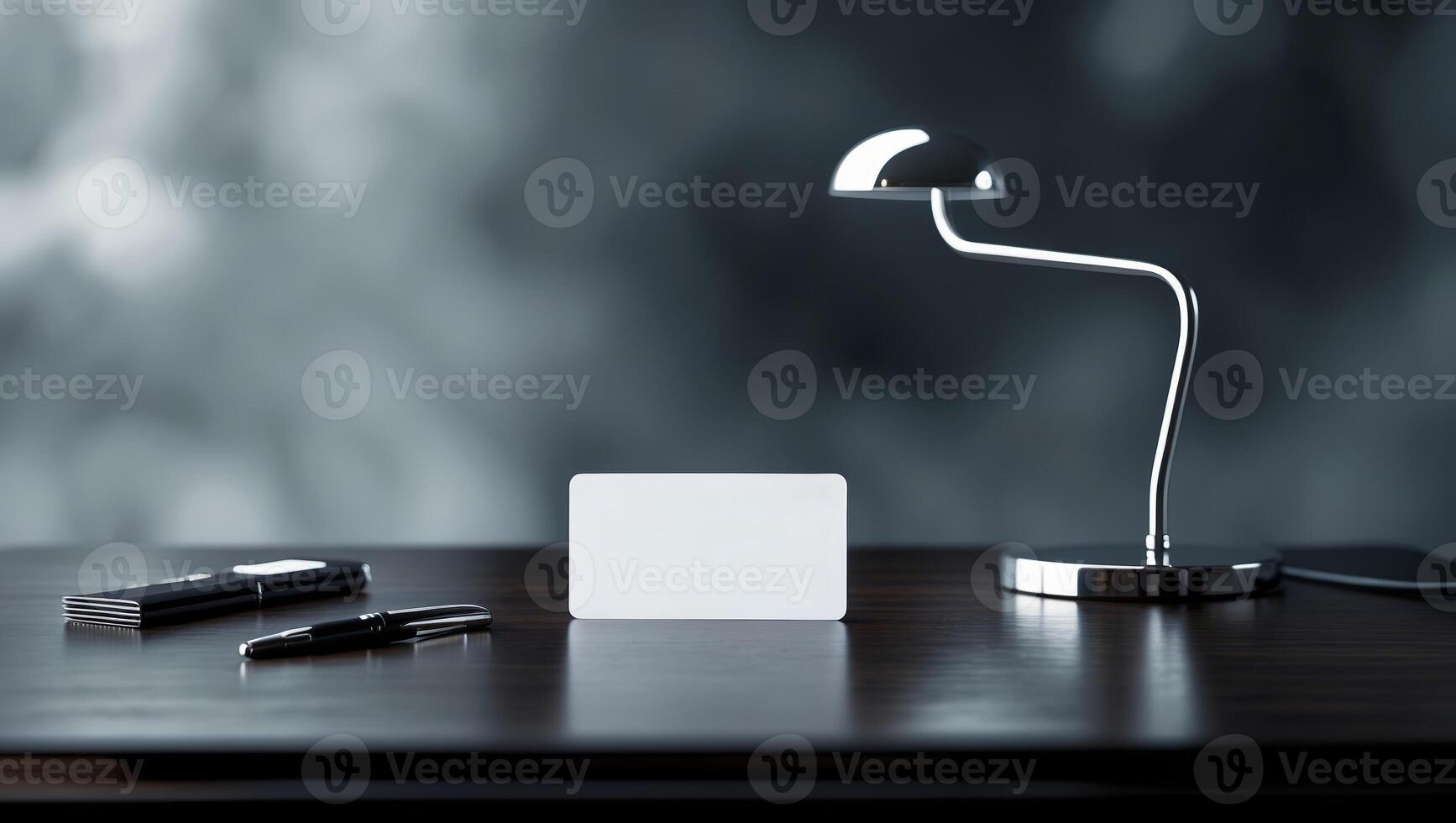 Elegant workspace with a sleek lamp, blank card, and pen on a modern wooden table in soft focus background photo
