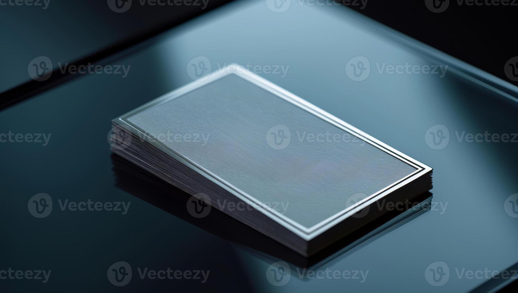 Blank business cards stacked neatly on a glass table, reflecting light in a modern workspace photo
