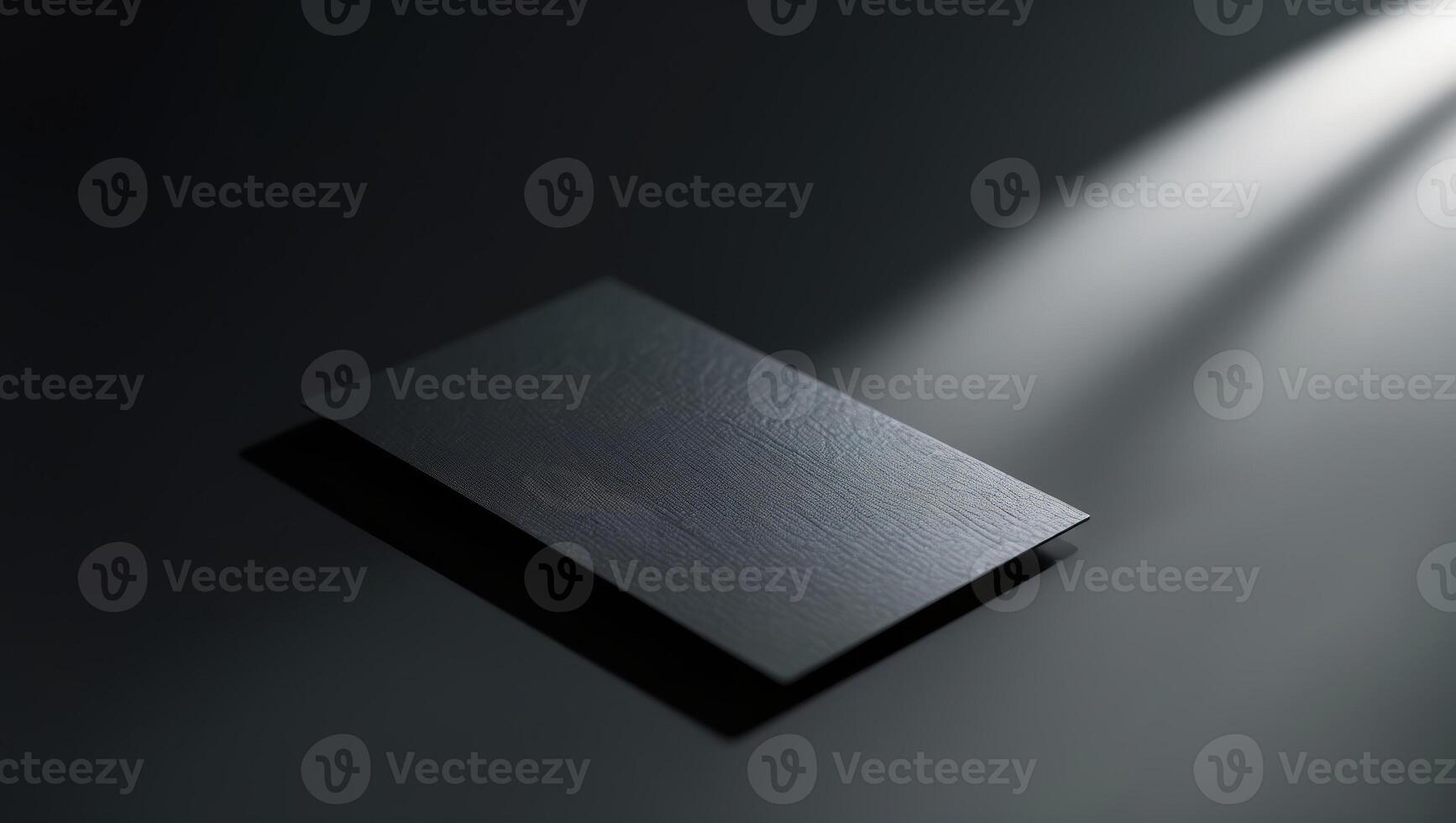 Sleek black business card illuminated by soft light in a minimalistic setting photo