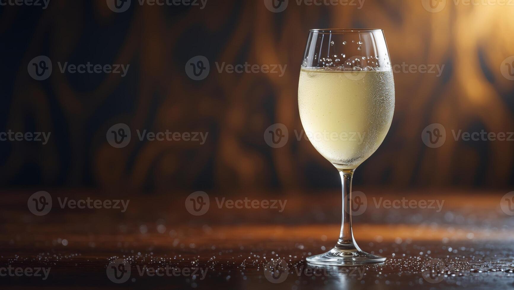 Sparkling beverage served in an elegant glass on a wooden table with a dark, textured background photo