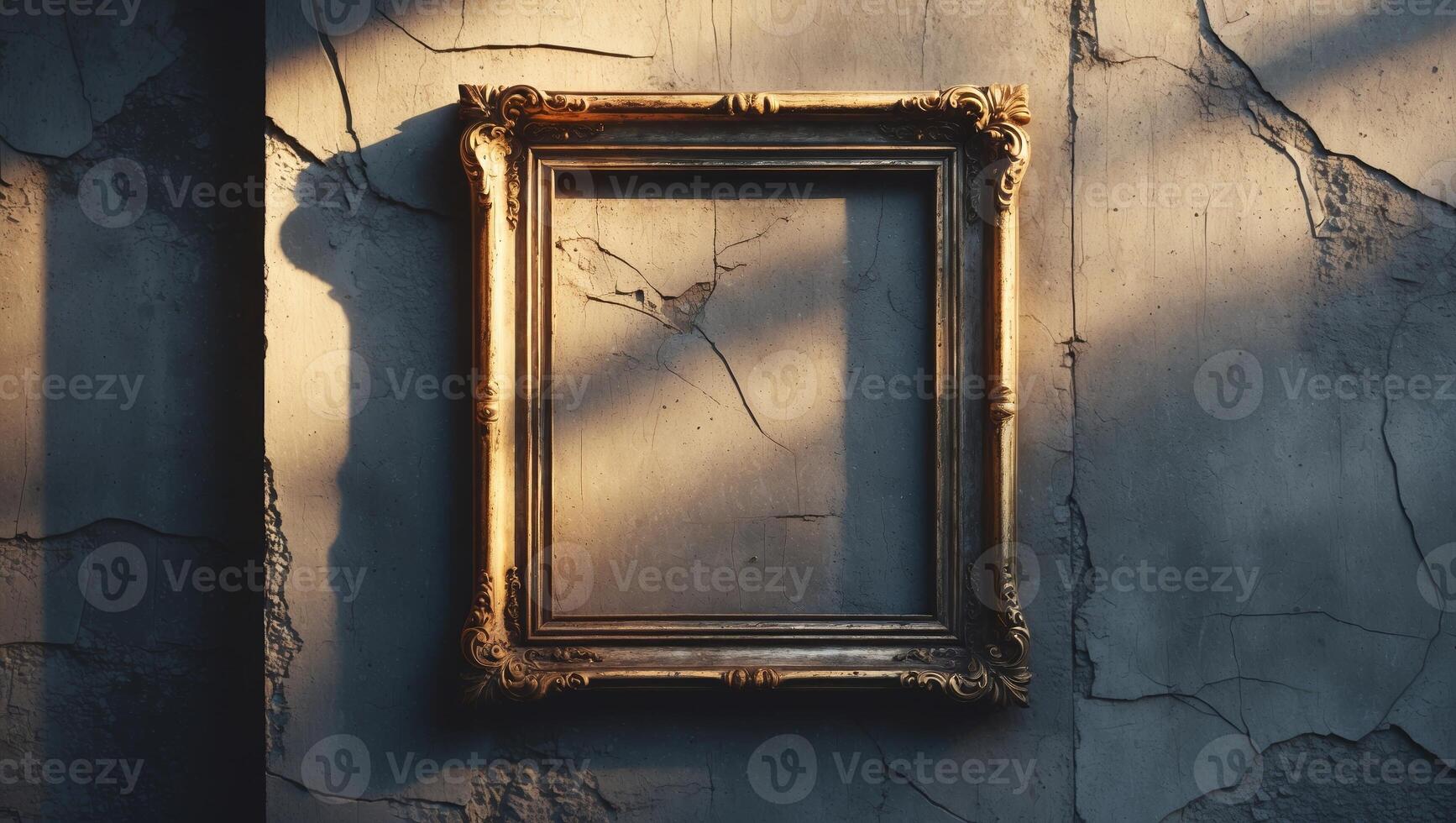 Empty ornate frame cast in soft sunlight against a cracked wall in an abandoned building photo