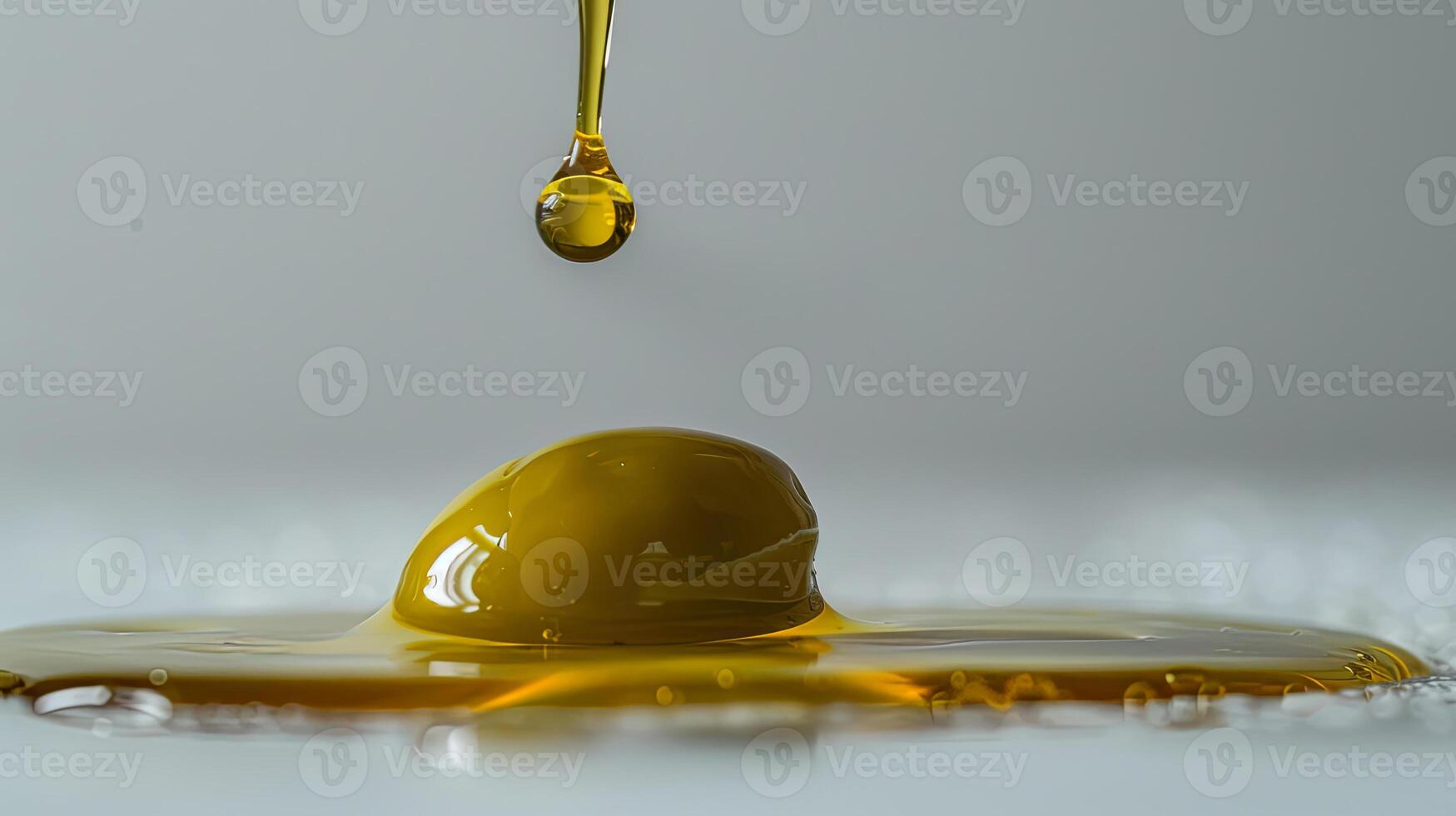 A drop of oil is being poured into a bowl photo