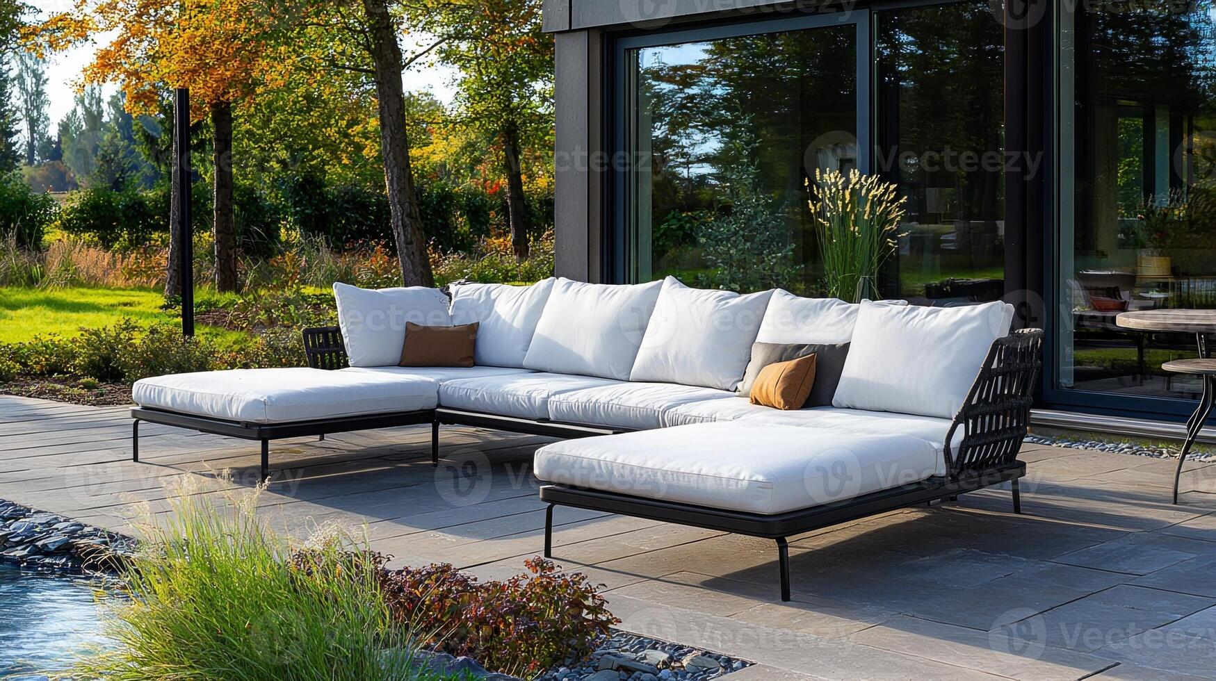 A large white sectional sofa is placed in front of a large window photo