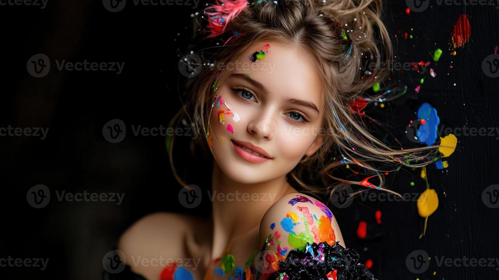 Beautiful girl with paint splatters on her face photo