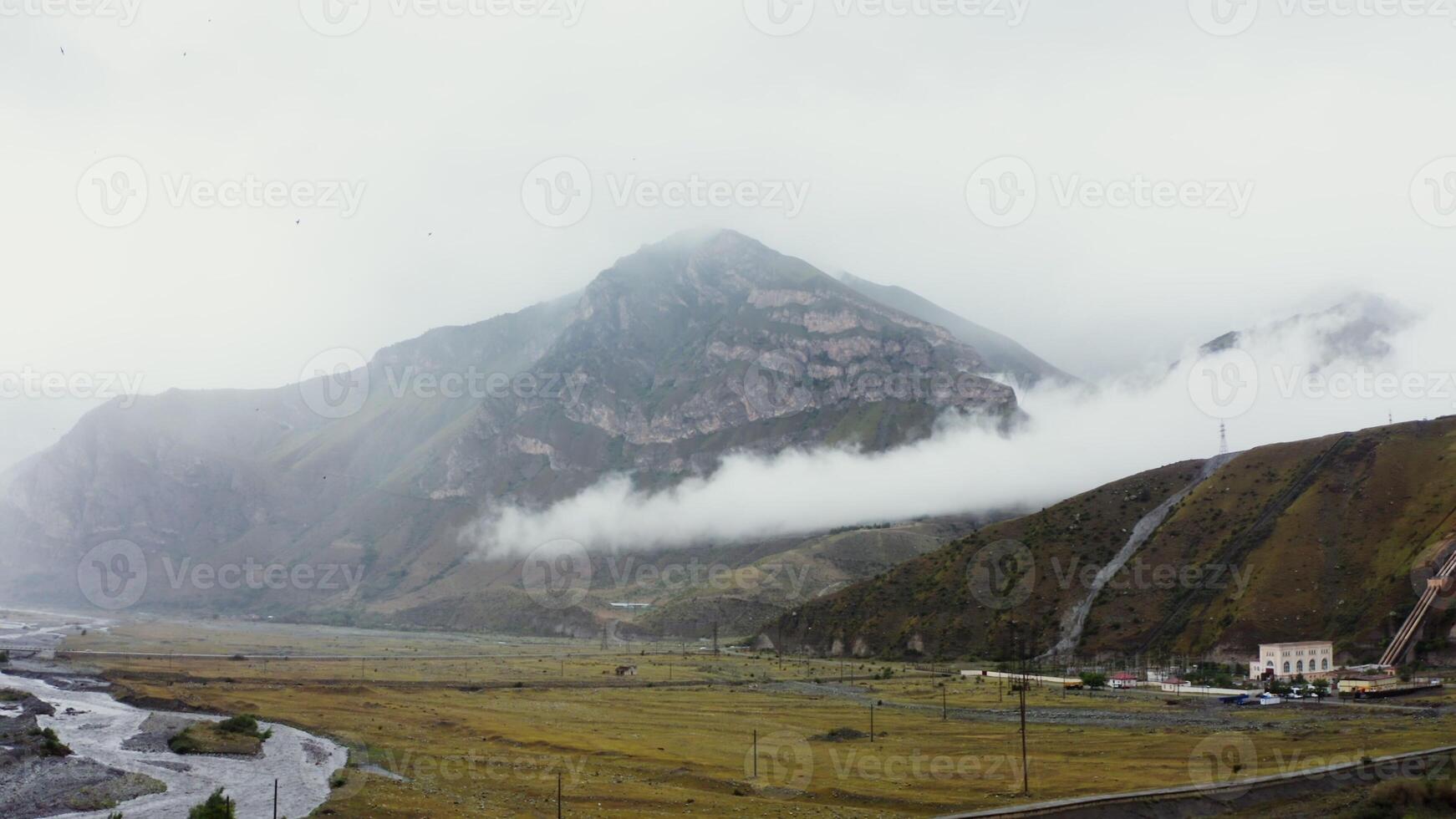 View of the mountain valley from quadcopter. Foot of hilly mountains and cliffs photo