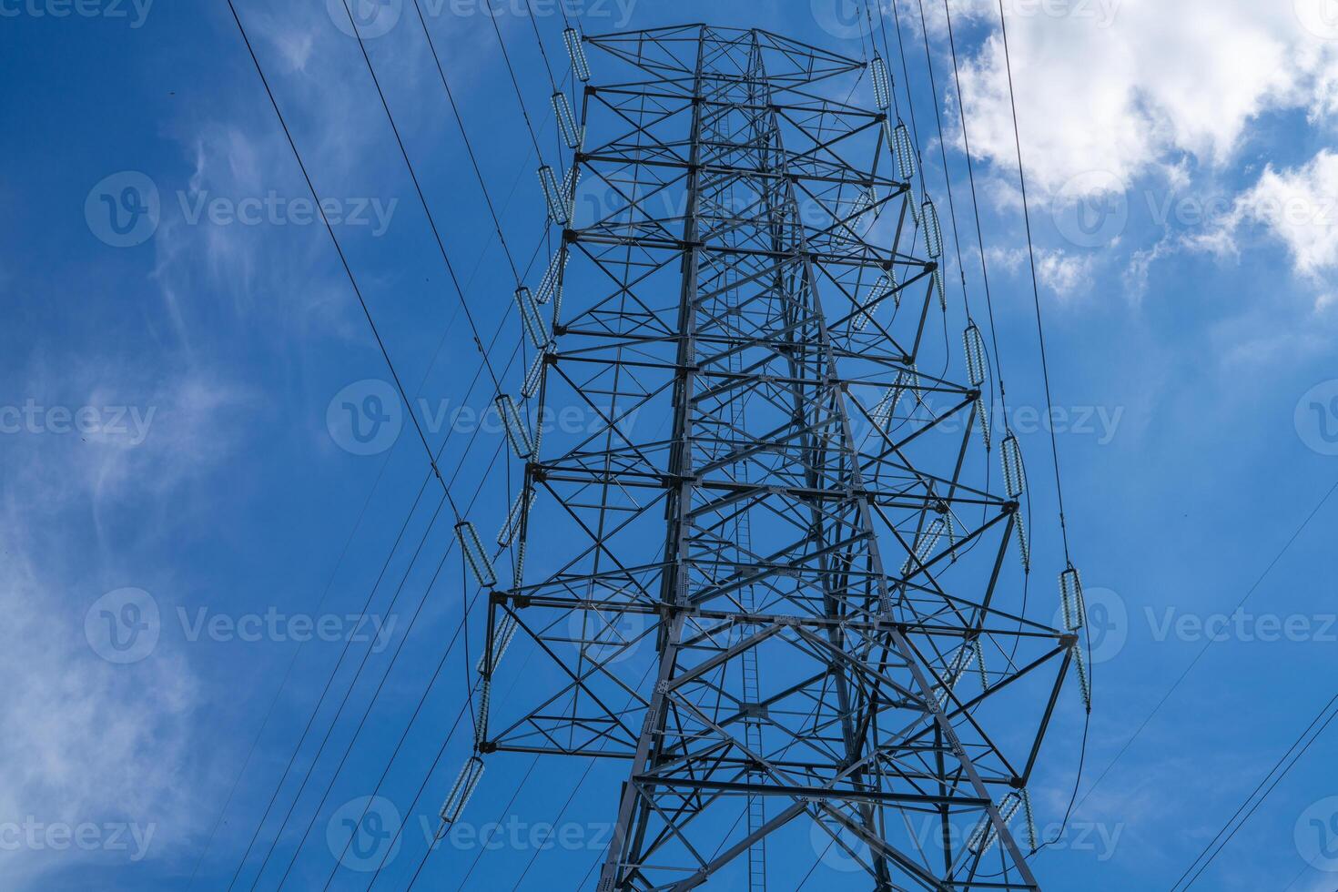 High voltage electrical transmission tower infrastructure delivers essential power across national grid system during peak energy demand showcasing critical utility distribution network photo