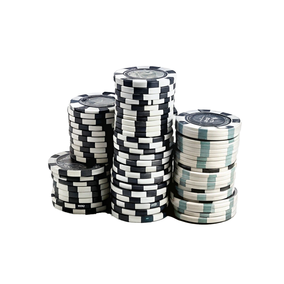 Closeup View of Three Stacks of Casino Poker Chips in Black and White and Teal Designs png