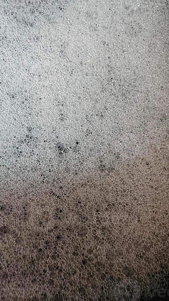 a close up of a black surface with white spots photo