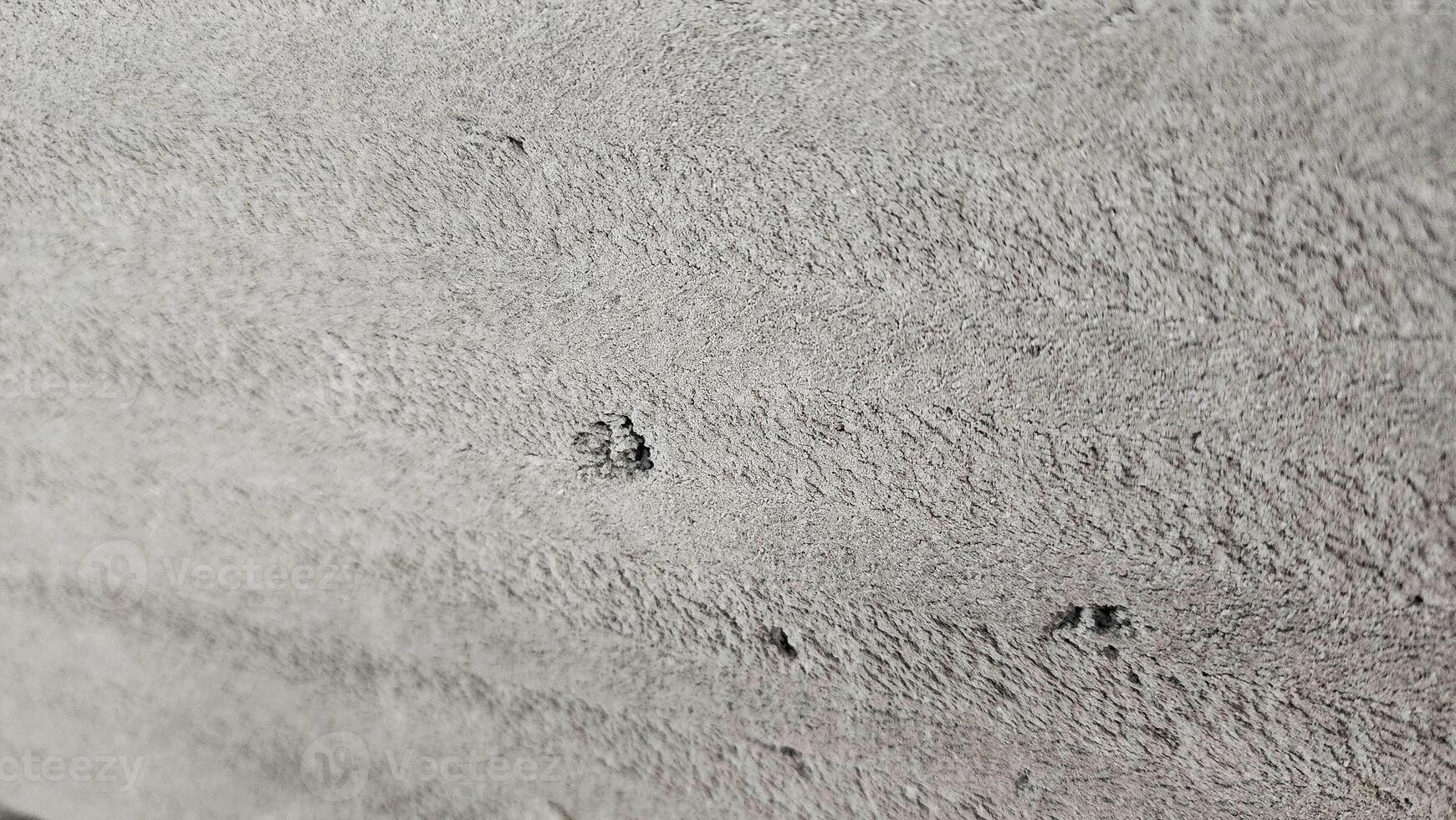 a close up of a concrete wall with holes photo