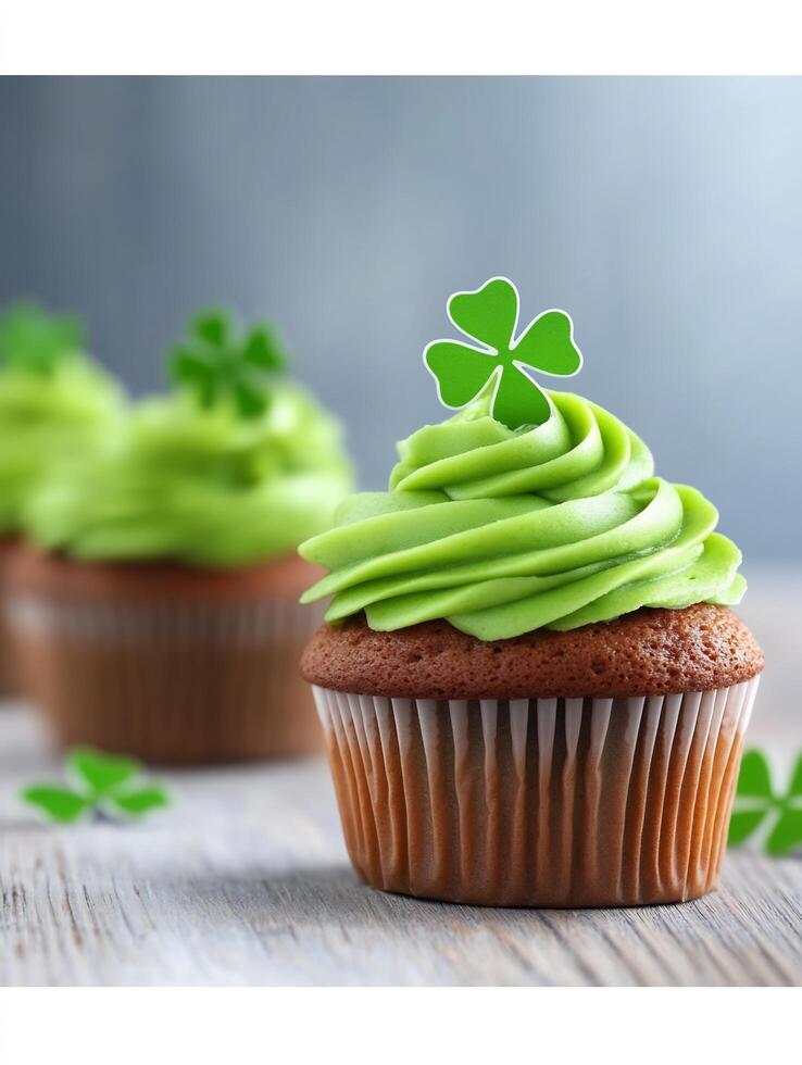 Three cupcakes with green frosting and shamrock leaves photo