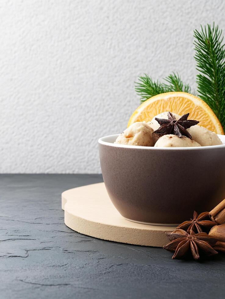 A bowl of ice cream with orange slices and cinnamon photo
