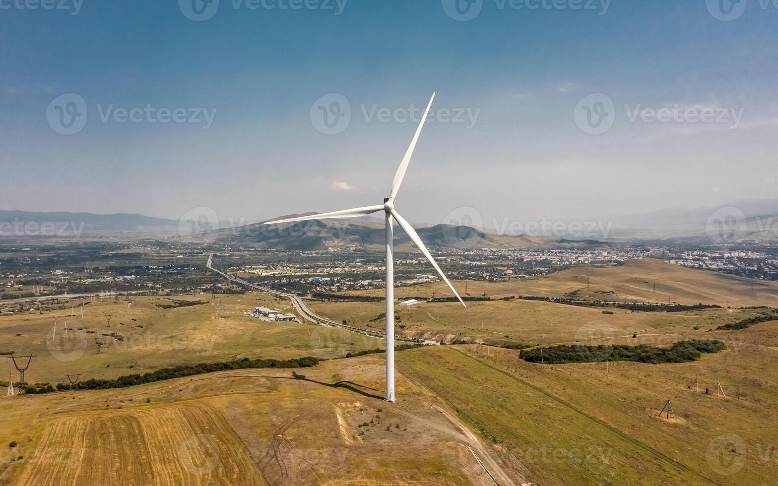 Aerial view of wind turbine rotating and generating energy photo