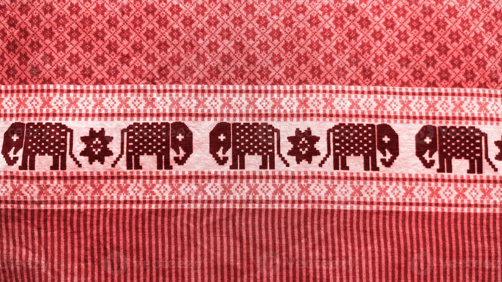 A red and black striped cloth with elephants on it photo