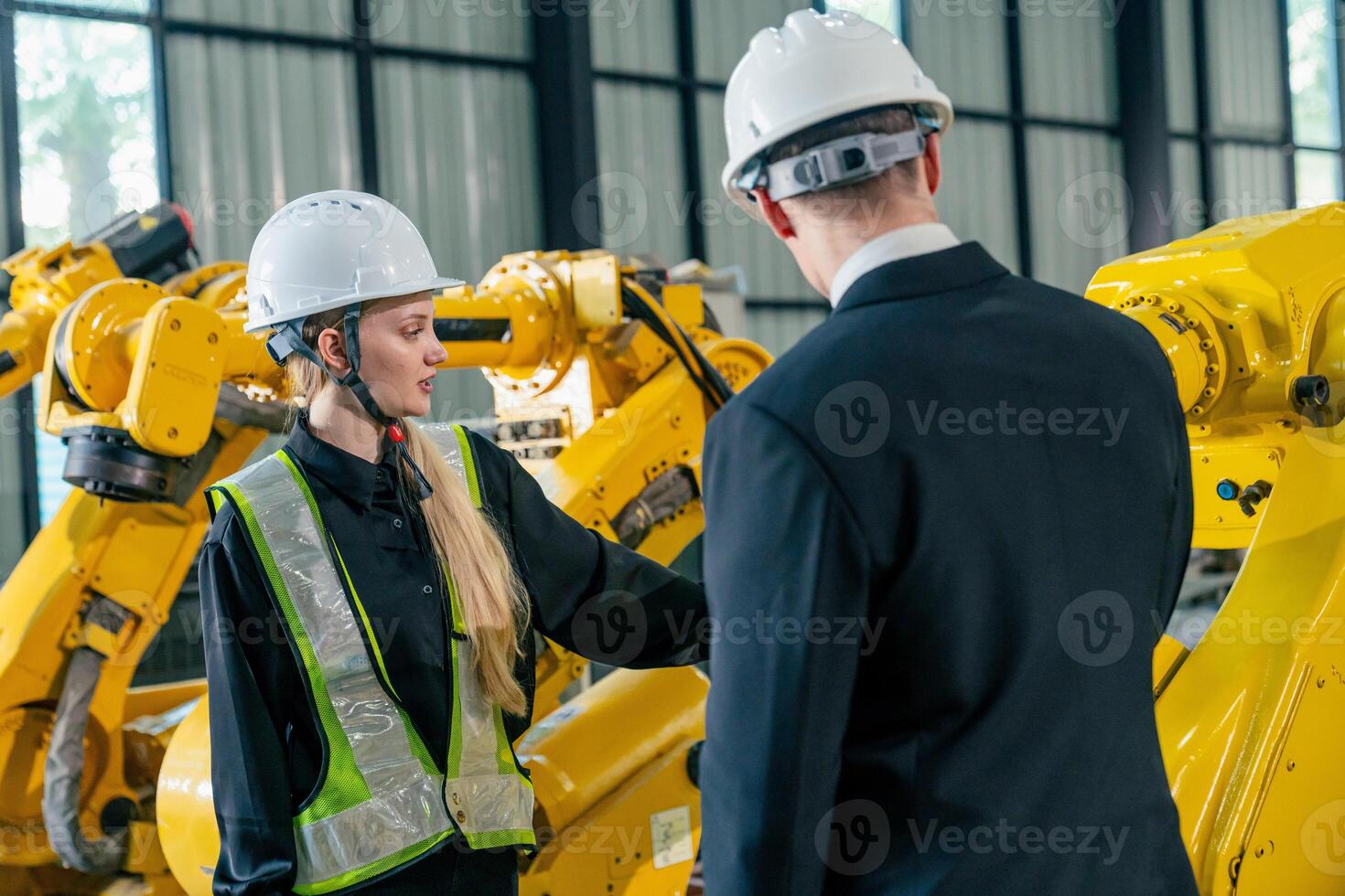 Industrial facility tour showcasing robotic automation and safety protocols with professionals photo