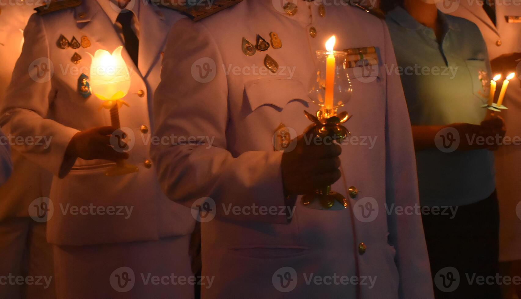 A man holding a candle in his hand photo