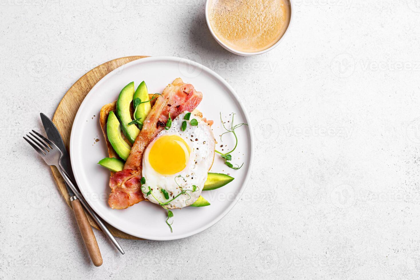 Toasted sandwich with fried egg, bacon, avocado, top view photo