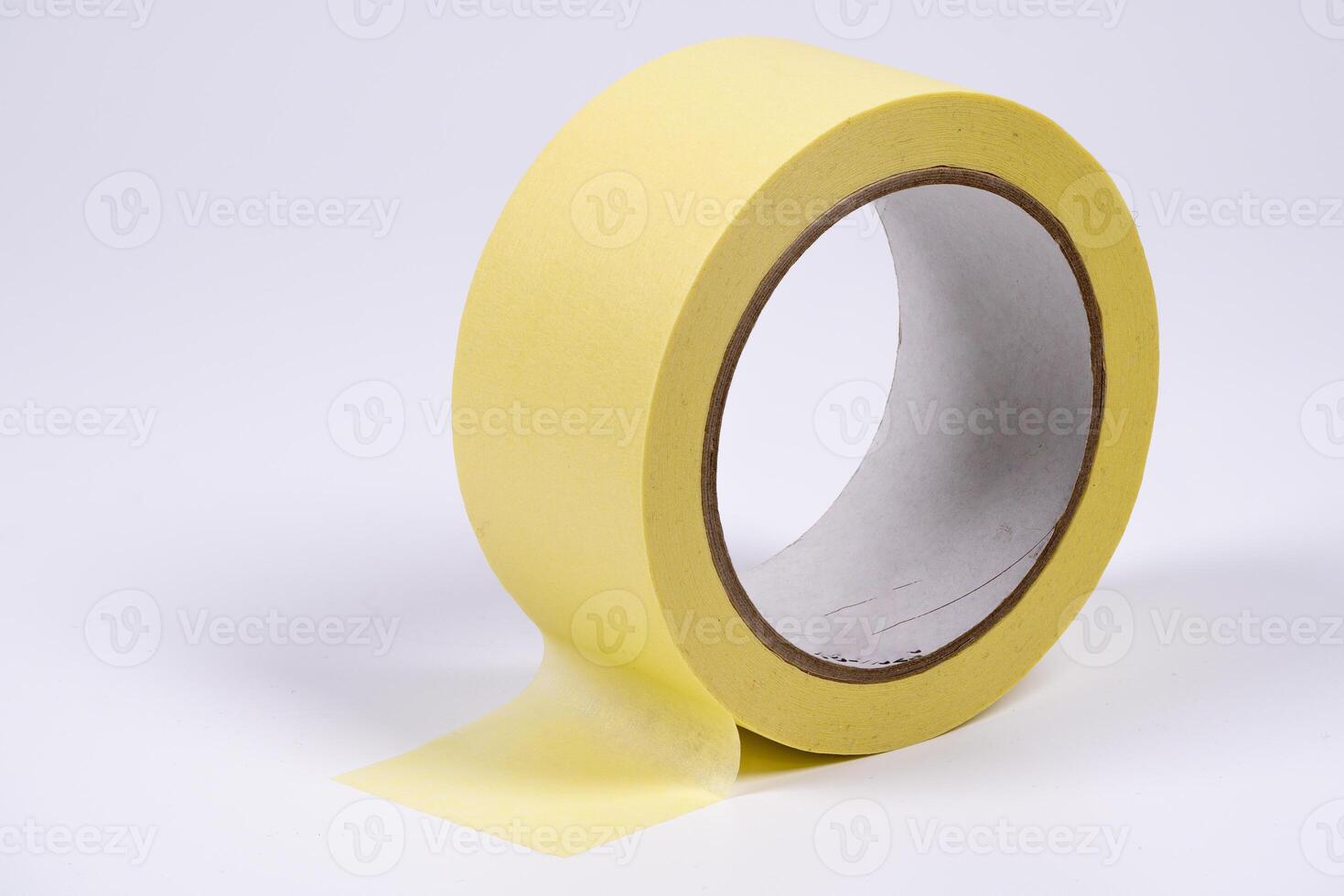 Yellow masking tape roll on white background highlighting adhesive quality photo