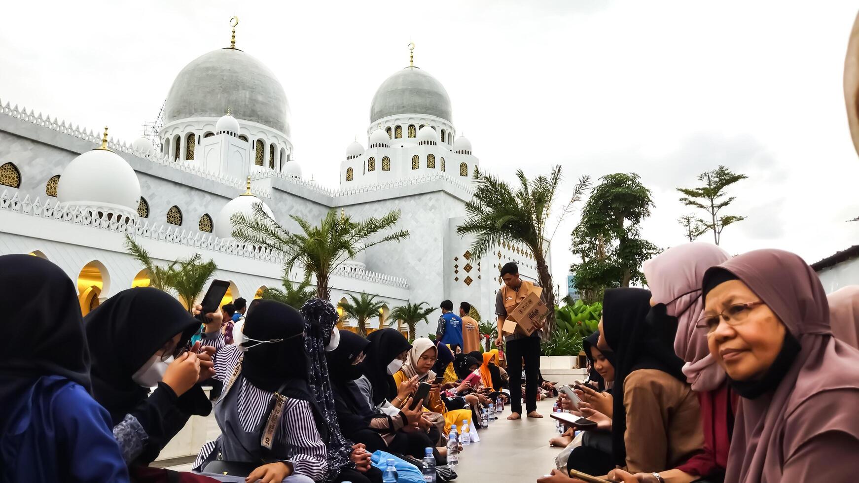 Surakarta, Central Java, Indonesia - April 14, 2023. Ramadan. Iftar. The atmosphere of preparing for breaking the fast together at the Sheikh Zayed Grand Mosque, Surakarta. photo