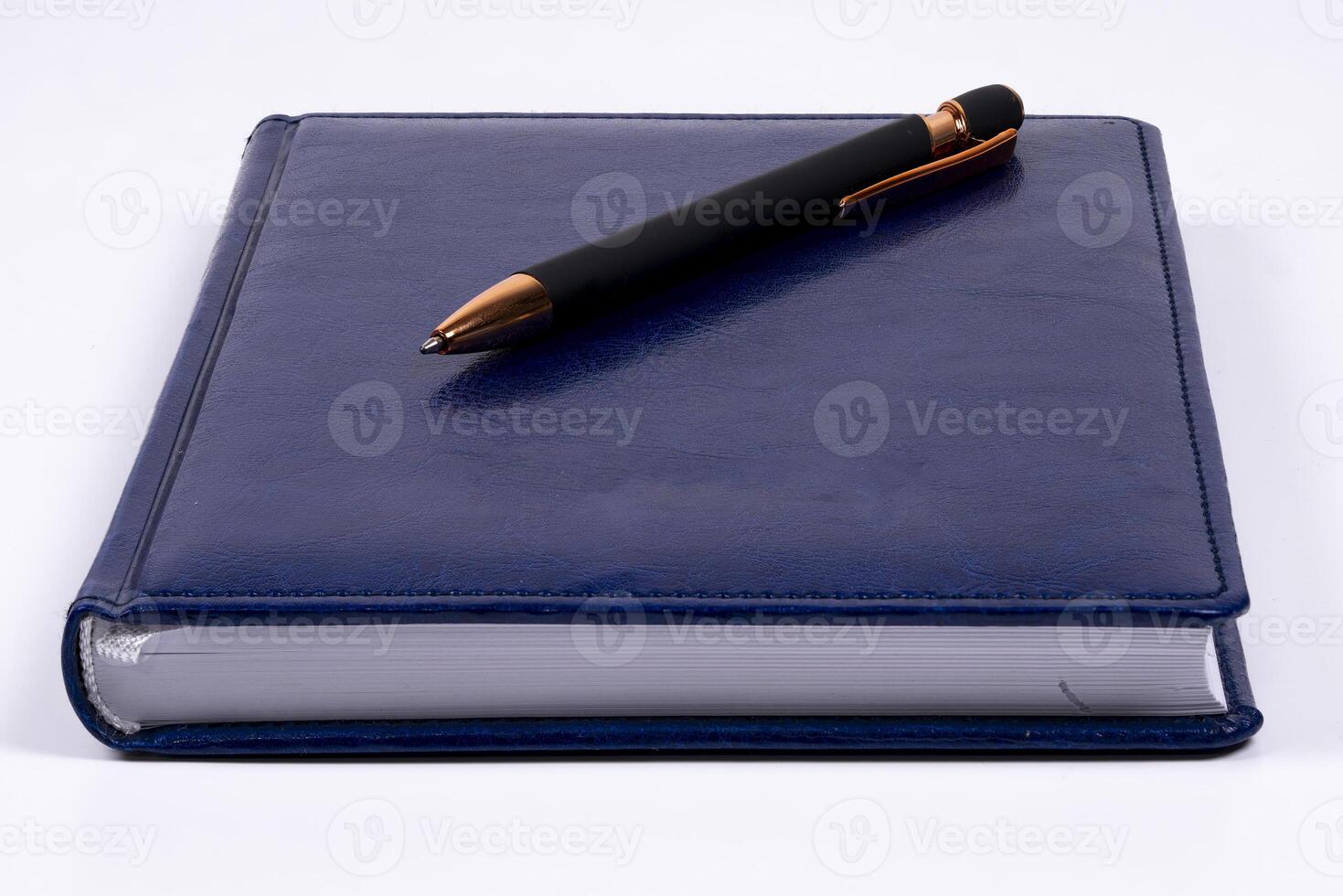 Elegant blue notebook with a stylish pen on a clean surface photo