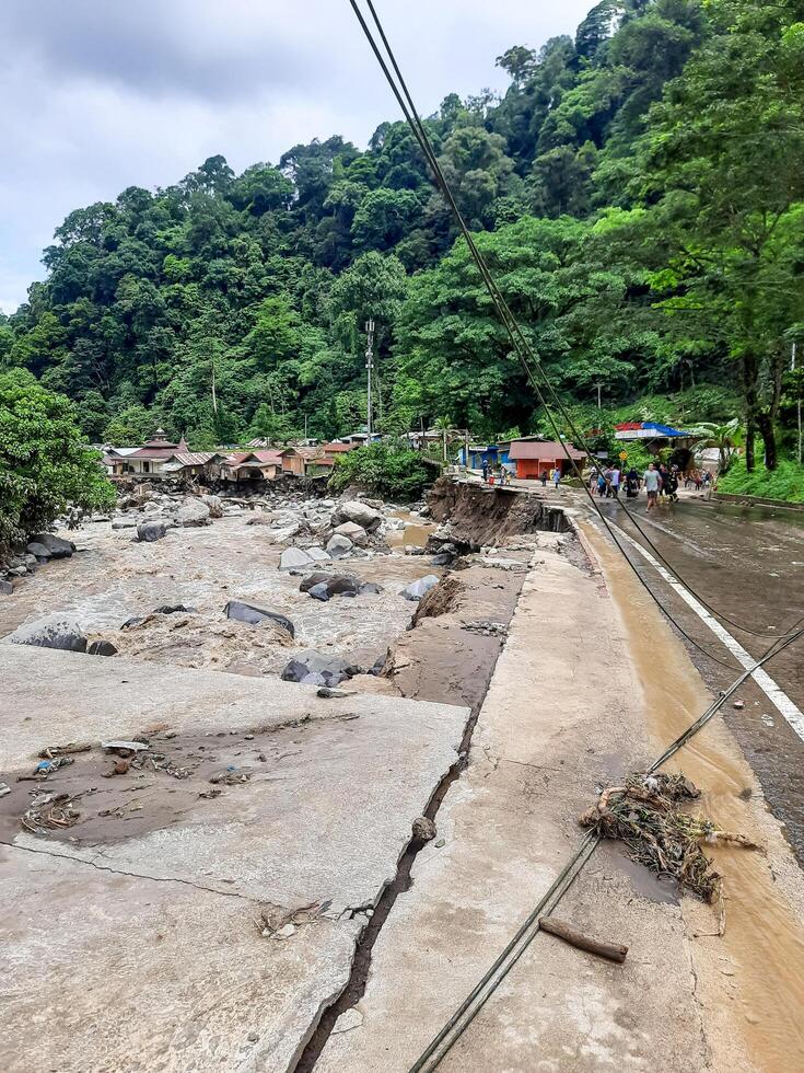 Tanah Datar, Indonesia - May 12, 2024. Dangerous part of landslip road section after cold lava flash floods, natural disasters in Lembah Anai, Sepuluh Koto, Tanah Datar, West Sumatra, Indonesia photo